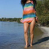 Skinny brunette hair undressing on the beach and playing in the warm water.